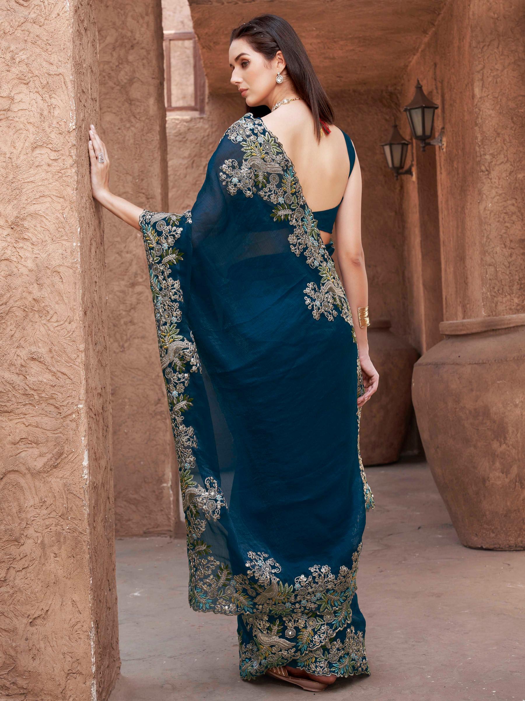 teal colored designer jimmy choo saree with sequinned embroidery border